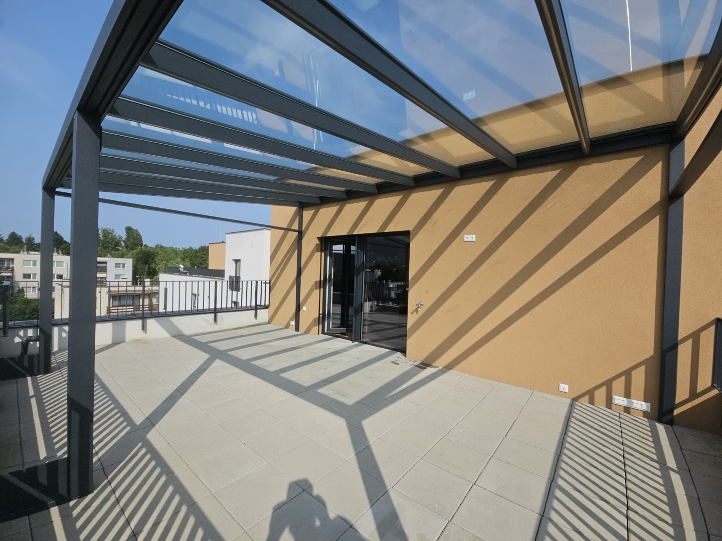 Moderná hliníková pergola s presklenou strechou na terase bytového domu